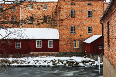 Houses by canal amidst buildings