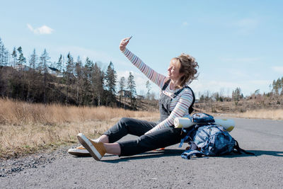 Woman taking a selfie whilst taking a rest from skating from yoga