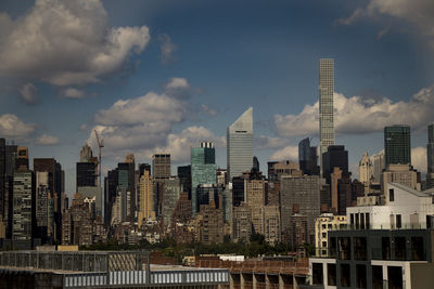 Panoramic view of buildings in city against sky