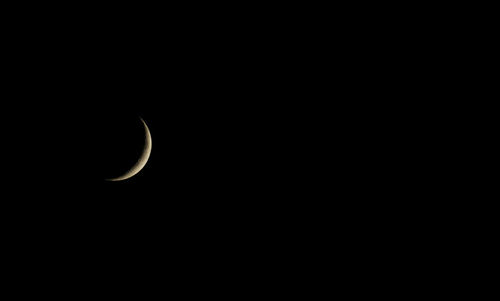 Low angle view of half moon against sky at night