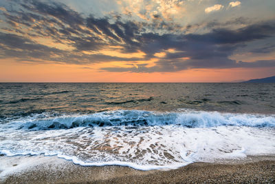 View of sea against cloudy sky during sunset