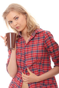 Portrait of young woman drinking coffee