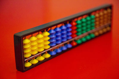 Close-up of abacus on red table