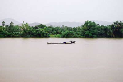 Boat in lake against clear sky