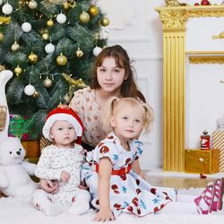 Portrait of family at home against christmas tree