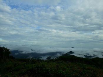 Scenic view of landscape against cloudy sky