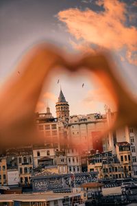 View of buildings in city at sunset