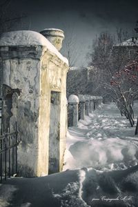 Snow covered built structure against sky