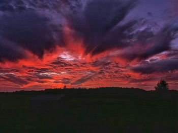 Silhouette landscape against dramatic sky