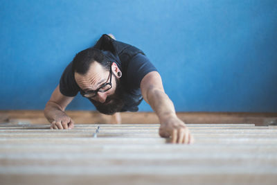 High angle view of man climbing in gym