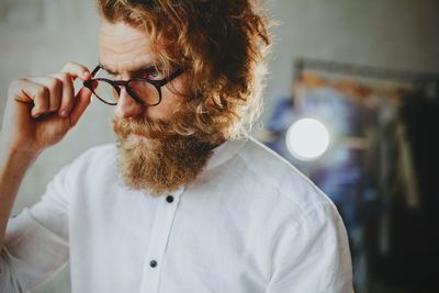 Portrait of man holding eyeglasses