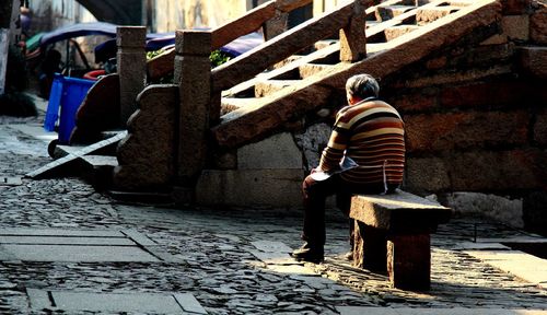 Full length of woman standing by railing
