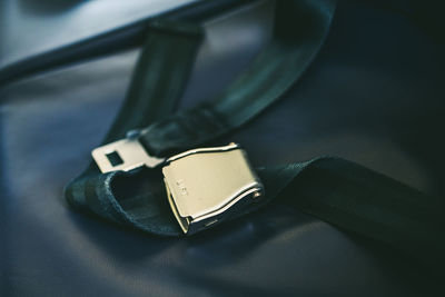 Close-up of seat belt on seat in airplane
