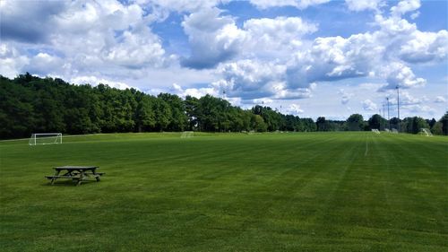 Scenic view of golf course against sky