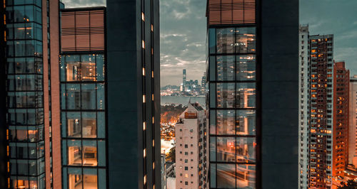 Buildings against sky seen through glass window