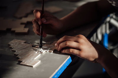 Close-up of person working on wood