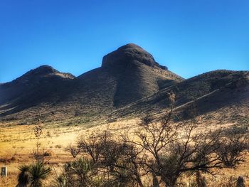 Low angle view of mountain against clear blue sky