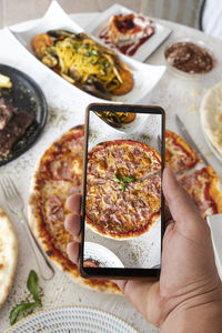 Cropped hand holding food