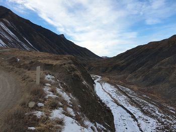 Scenic view of snowcapped mountains against sky