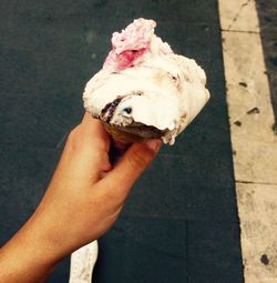 Cropped hand holding ice cream cone