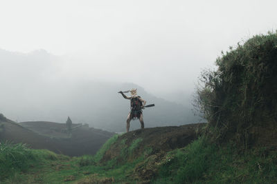 Man on mountain against sky