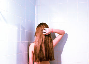 Rear view of woman in bathroom