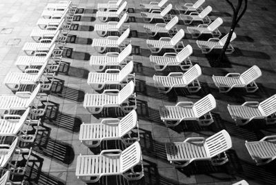 High angle view of empty chairs in row on promenade