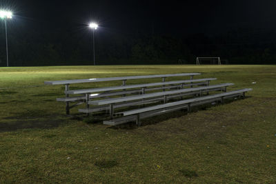 Empty seats in park at night