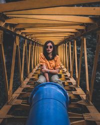 Portrait of young woman sitting on water pipe