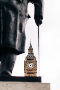 Low angle view of clock tower against building in city