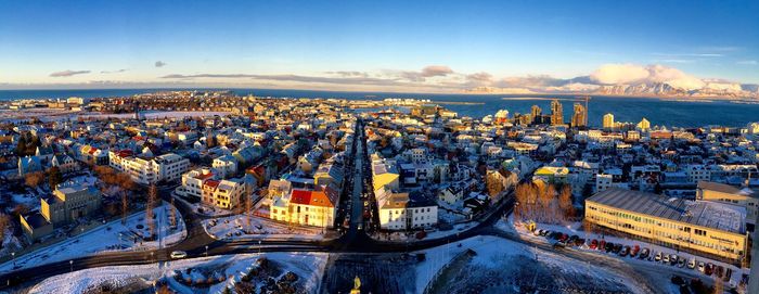 High angle view of cars on road along buildings during winter