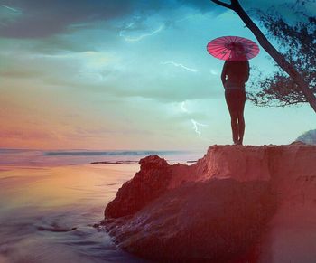 Rear view of woman standing on beach