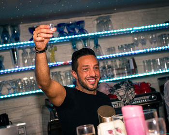 Portrait of happy man with shot glass