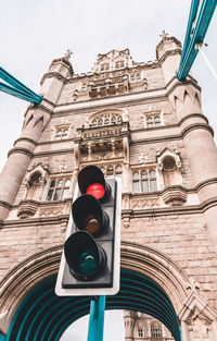 Low angle view of road signal against building