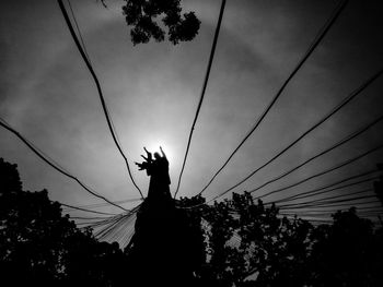 Low angle view of power lines against sky