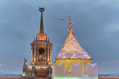 Spire of yekaterinburg city administration building with lighting,ice house with glowing garlands 