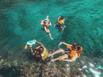 High angle view of people swimming in sea