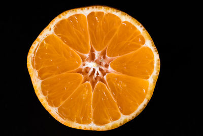 Close-up of lemon slice against black background