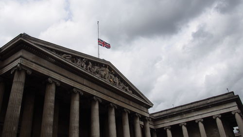 Low angle view of building against cloudy sky