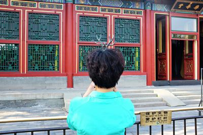 Rear view of woman standing in park