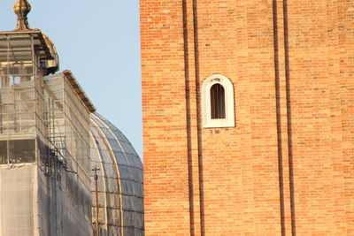 Low angle view of window on brick wall building