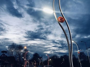 Low angle view of illuminated street light against sky