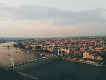 High angle view of river amidst buildings in city against sky