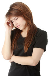Beautiful young woman looking away against white background