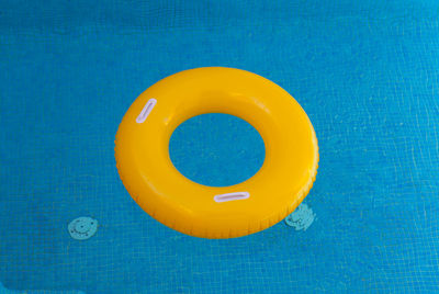 High angle view of yellow blue floating on swimming pool