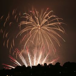 Low angle view of firework display at night