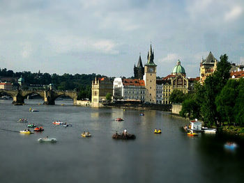 Boats in river with buildings in background