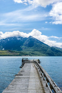 View of pier on lake against cloudy sky