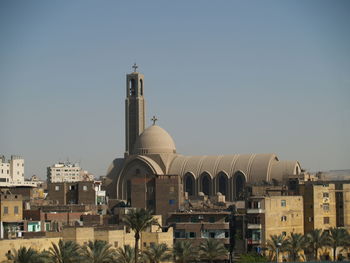 Church in city against clear sky