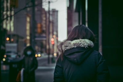 Rear view of man and woman on street